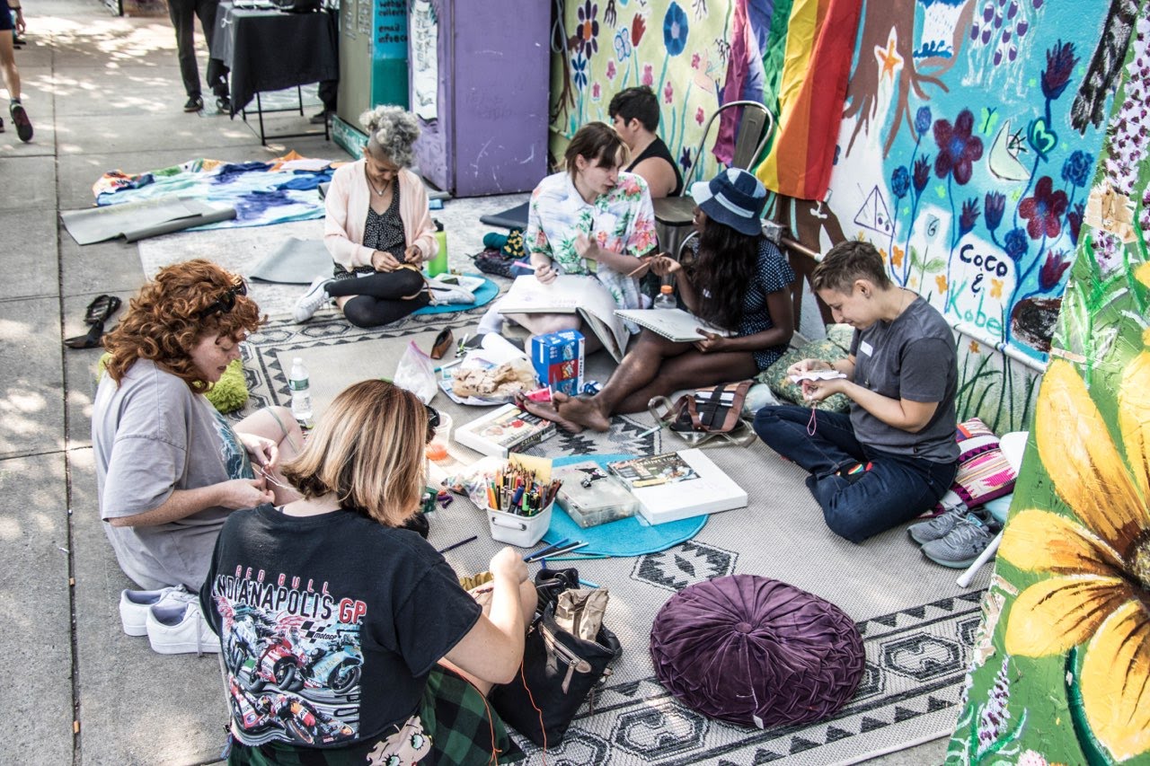 Group of people participating in a Queer Craft Club meetup (photo by Dee Moore)